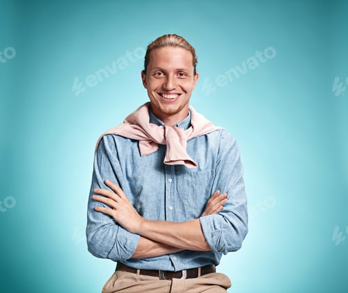 Preview: Happy Excite Young Man In Blue Shirt Smiling And Celebrating His Succcess Over Blue Studio