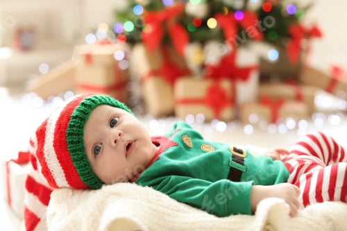 Preview: Cute baby in Christmas costume at home