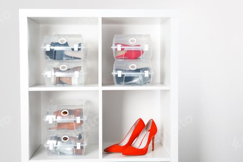 Preview: Footwear and plastic boxes on shelves near wall. Shoe storage organization