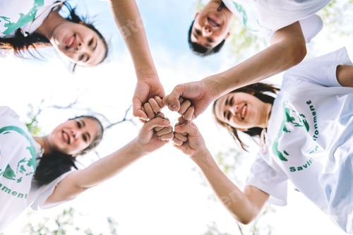Preview: Group of diverse people volunteer team with hand stack to show teamwork spirit