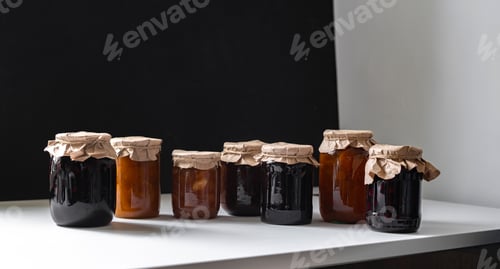 Preview: row of the pickled jars with marinated food on the shelf, homemade grocery