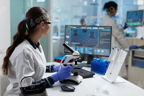 Preview: Biologist researcher doctor doing chemistry experiment using medical microscope