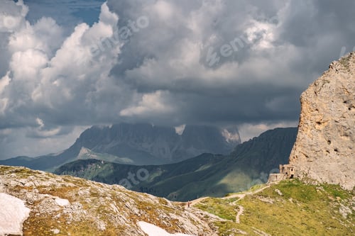 Preview: Scenic Alps with rocky mountain under cloud sky