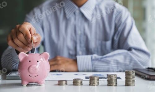 Preview: Businessman with a coin in a piggy bank along with pressing the calculator and writing down savings
