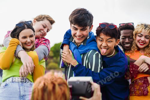 Preview: Young diverse people having fun with old vintage camera outdoor - Soft focus on asian man hand