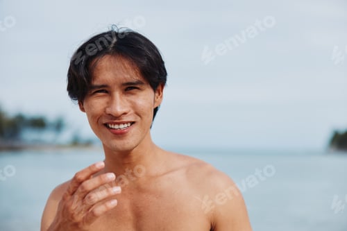 Preview: Muscular Asian Man Smiling on Beautiful Tropical Beach, Enjoying Summer Vacation