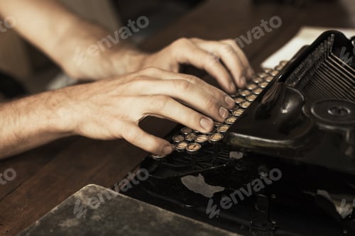 Preview: Young man's hands typing on an antique vintage typewriter