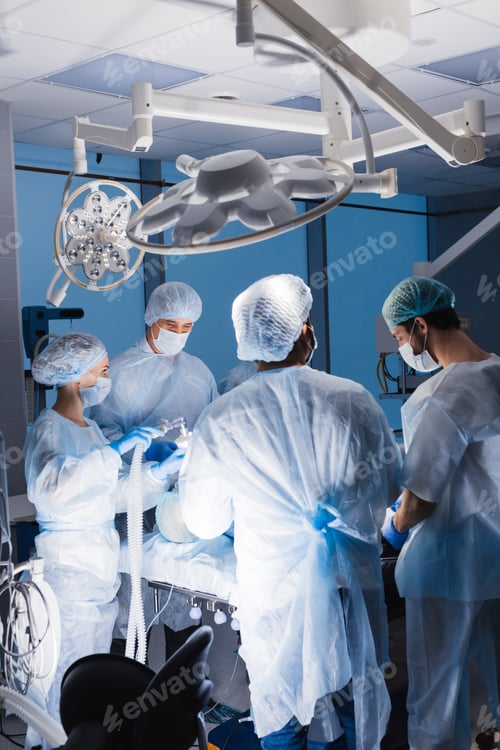 Preview: Team of anesthetists preparing patient for surgery at the operating room