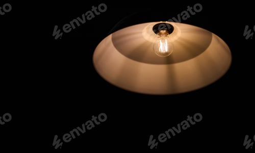 Preview: The electrical light bulb on black background
