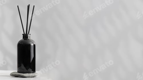 Preview: Bamboo sticks in a black bottle with indoor perfumes. Glass diffuser with fragrance. Copy space