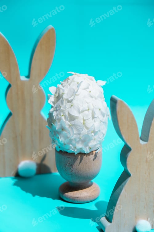 Preview: Creative Easter egg shape made of white lilac spring petals flowers. Responsible holidays decoration