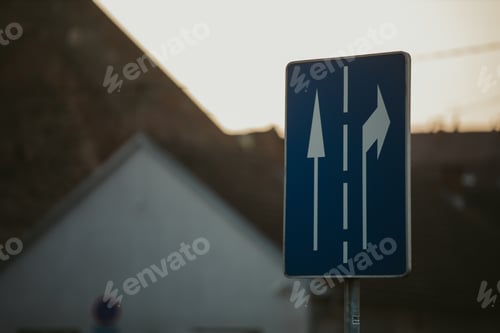 Preview: Closeup shot of a traffic sign with two arrows in different directions on a blue background․