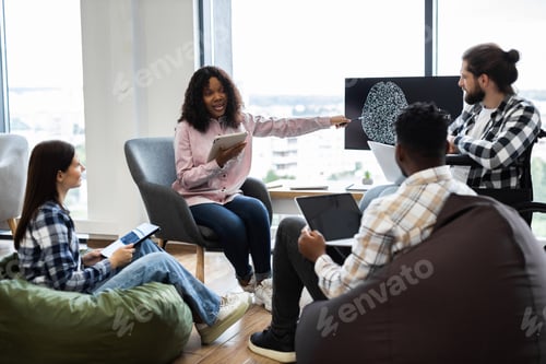 Preview: Team collaborating on artificial intelligence project in office