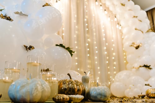 Preview: Decorated arch for wedding ceremony. White balloons, candles, autumn leaves and small pumpkins.