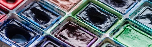 Preview: close up view of watercolor dirty colorful paint palette, panoramic shot