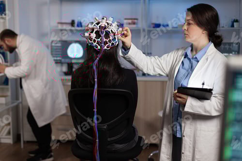 Preview: Specialist neurologist doctor monitoring brain evolution of patient with eeg headset