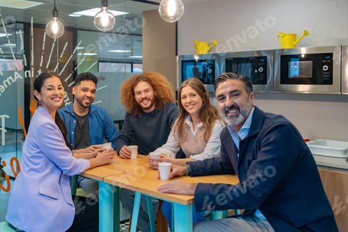 Preview: Team meeting over coffee in office kitchen.