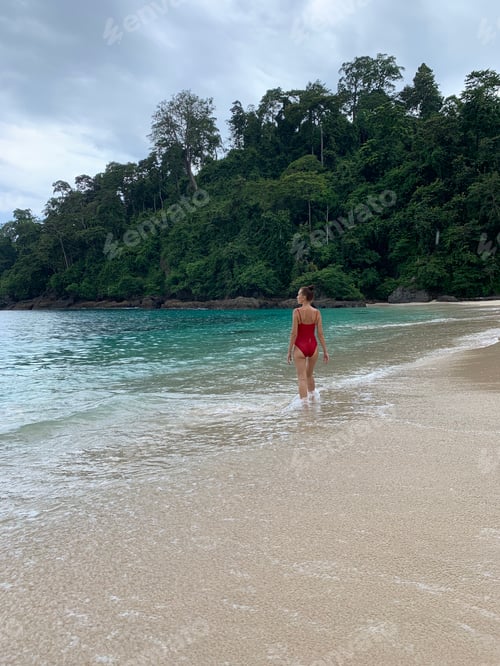 Preview: Woman in red bikini on white sand relaxed beach