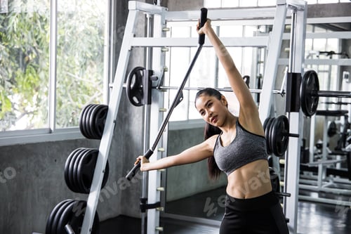 Preview: Fitness girl exercising in the gym.