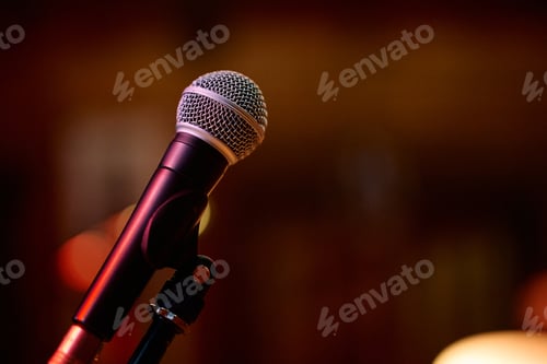 Preview: Microphone ready for a heavy metal concert with energetic crowd in background