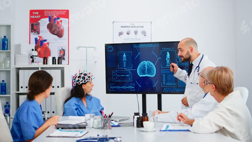 Preview: Neurologist showing new inovation for brain control to colleagues