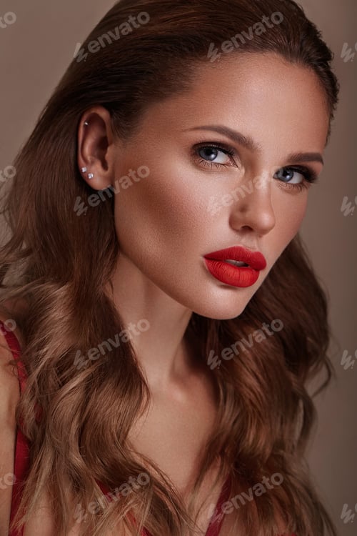 Preview: Beautiful sexy woman in a Hollywood manner with curls, natural makeup and red lips.. Beauty face and