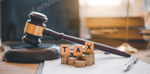 Preview: Tax law concept. Wooden blocks word " TAX" on coin stack .with gavel and money on the table.