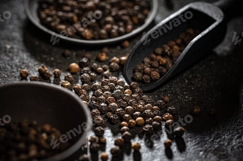 Preview: Black peppercorns in black wooden shovel
