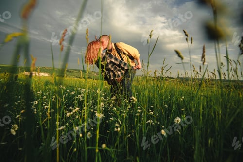 Preview: Loving hipster couple walking in the field, kissing and holding hands, hugging, lying in the grass