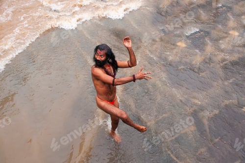Preview: A Sadhu offering prayer in Godavari river during the Simhastha Kumbh Mela, India.
