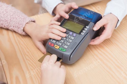 Preview: cropped view of kid paying with credit card in payment terminal