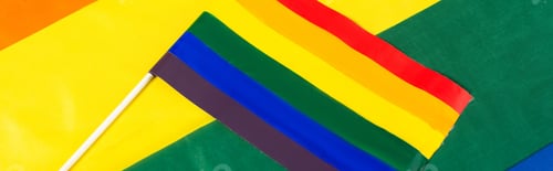 Preview: top view of lgbt flag on rainbows colors background, banner