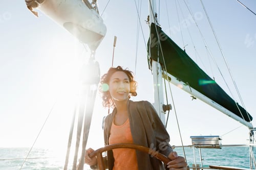 Preview: Young woman steering yacht