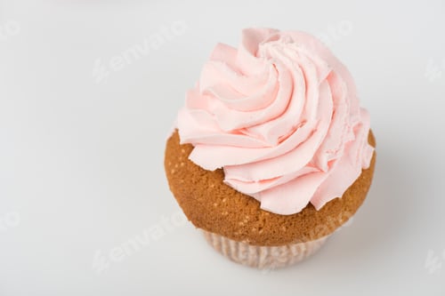 Preview: one tasty cooked pink cupcake on white