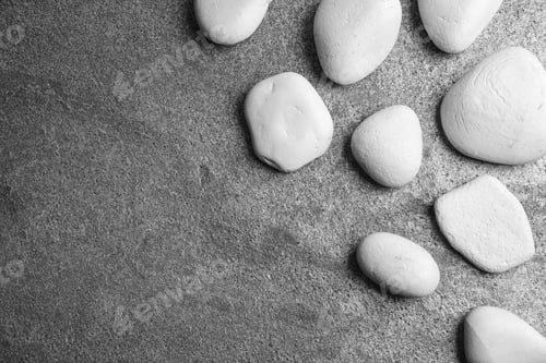 Preview: Zen stones on grey background, top view with space for text