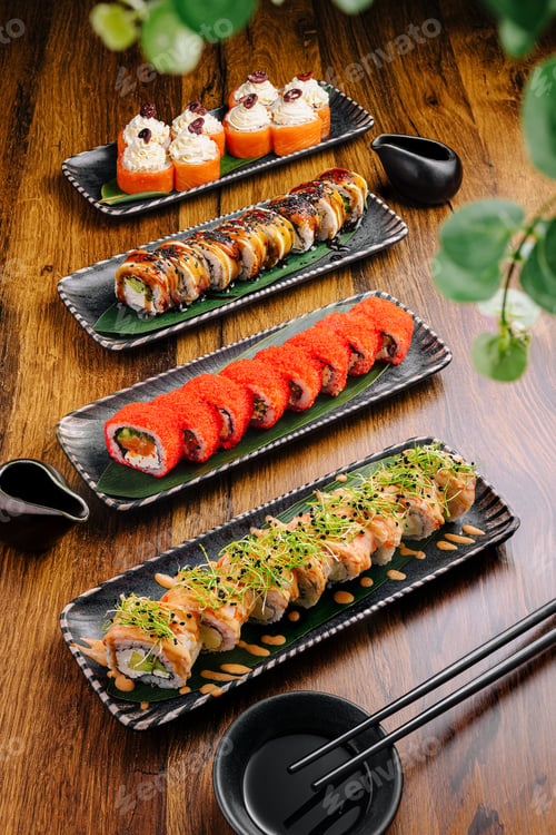 Preview: Artfully arranged sushi rolls on wooden table in Japanese restaurant setting