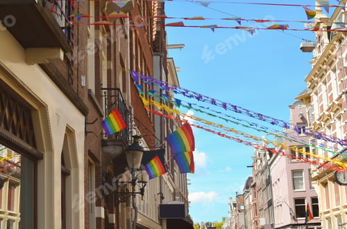 Preview: Bright rainbow LGBT pride flags on building facade