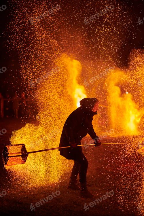 Preview: Silhouette of Two Fire Performers Creating Sparks Against Night field