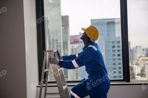 Preview: Construction, young worker working under factory construction.