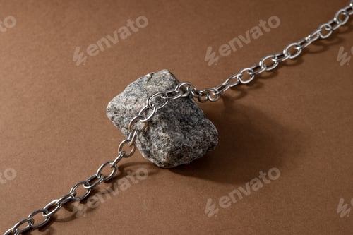 Preview: Minimalist beige brown still life composition with natural material: stone and steel chain