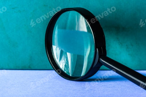 Preview: Magnifier on blue background close up