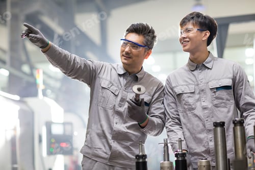 Preview: Confident engineers working in the factory