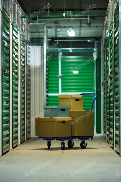 Preview: Stacked Cardboard Boxes on Trolley Standing Inside Self Storage Facility