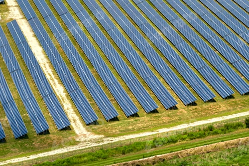 Preview: Aerial view of large sustainable electrical power plant with rows of solar photovoltaic panels