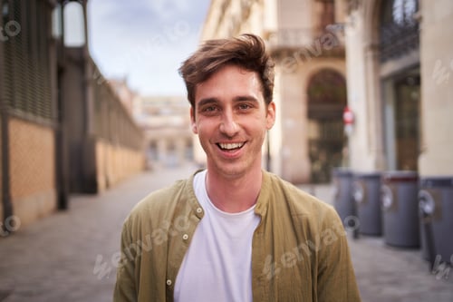 Preview: Close up portrait of happy young European man happy smiling face on street. Male people cheerful.
