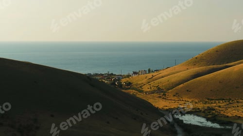 Preview: Top view of the village near the sea near the hills. Shot. Beautiful Sunny day in the village by the