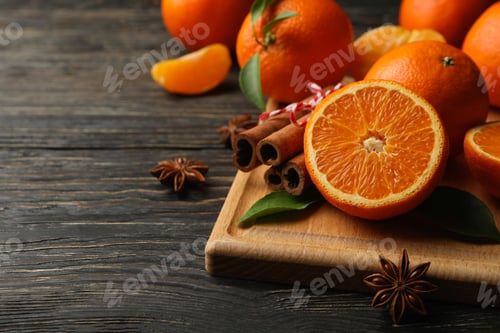 Preview: Board with mandarins and cinnamon on wooden background