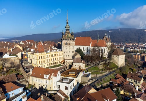 Preview: Aerial shot of Sighisoara fortress in Romania with urban town in distance