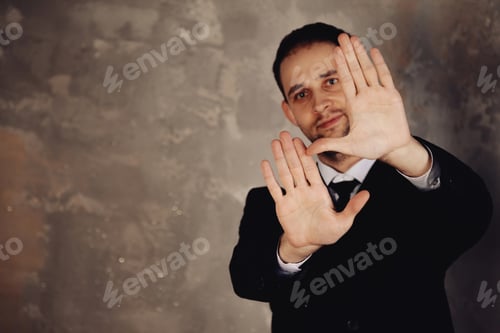 Preview: Man in a Suit Frames View With Hands Offering Creative Copy Space