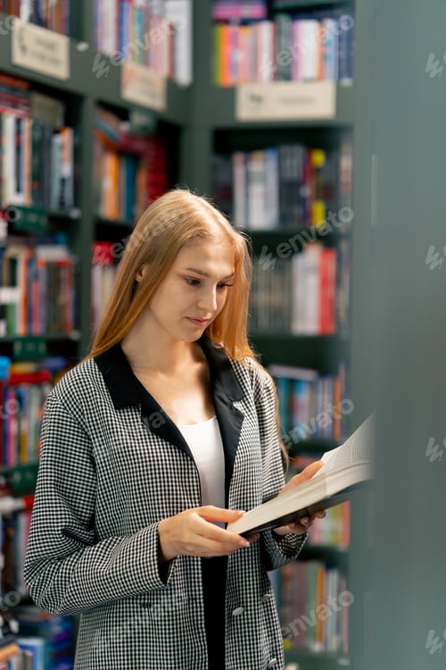 Preview: woman hand in a bookstore young girl chooses a new book for herself preparing for exams student